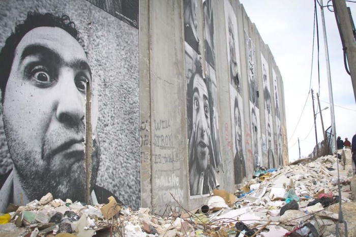 Artwork and graffiti cover the barrier between Jerusalem and the Palestinian West Bank, which was created by the Israeli government following the Second Intifada. Referred to as everything from an apartheid wall to a security fence, ideas about the barrier are reflective of multiple narratives of the conflict. (Photo by Sam Shonkoff)