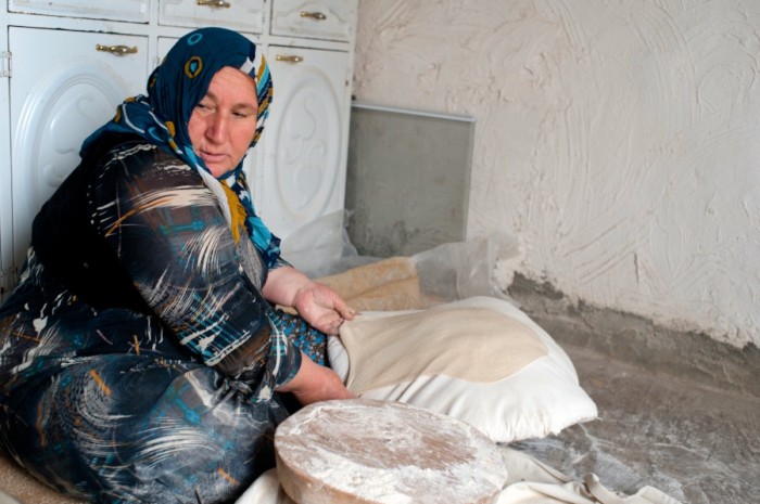 A woman stretches lavash over a pillow in Halabja, in Iraqi Kurdistan. (Photo by Naomi Duguid)