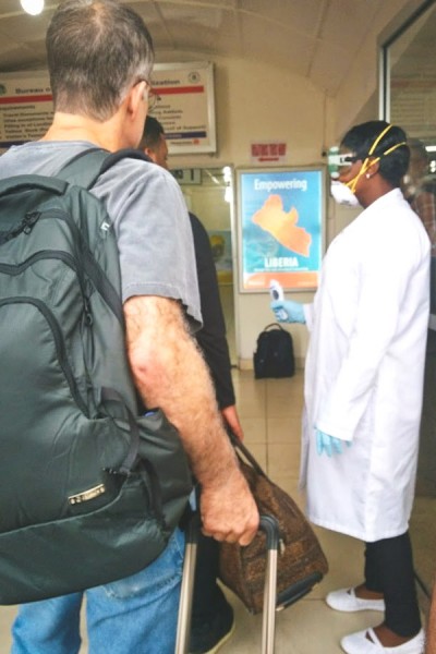 One of many checkpoints around Liberia (this one at the Monrovia airport) where everyone is checked for symptoms of Ebola — sometimes with faulty equipment. (Photo by Karin Huster)