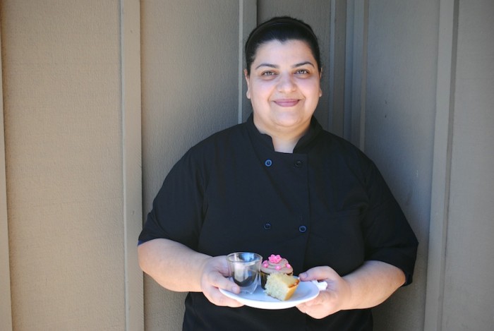 Taghreed Ibrahim, in the second cohort of paid Feast apprentices, holds some of her baked goods used in a food photography shoot. (Photo by Anna Goren)