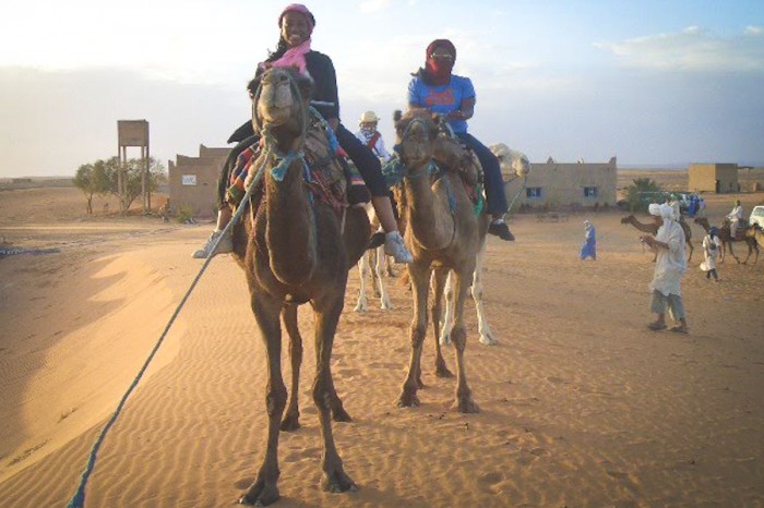 Kathy Norris (left) and the author riding camels in Morocco.