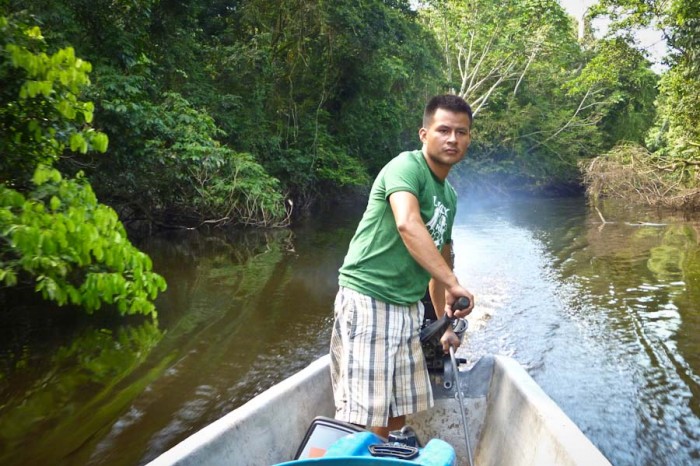 Hugo Lucitante pilots a boat on the Ecuadorian Amazon, on the land of the Cofán people, which is threatened by oil extraction. (Photo courtesy Oil & Water)