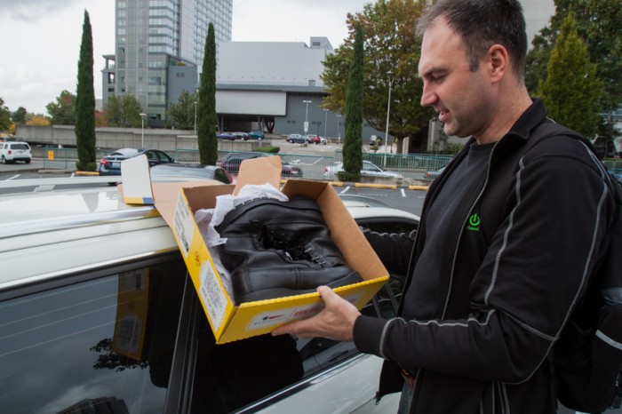 “The reason I was late was because I drove to Seattle to pick up boots. Tomorrow I’m going to drive to Olympia to pick up suits for soldiers,” said Krasnovsky holding up the shoe box. (Photo by Kseniya Sovenko)