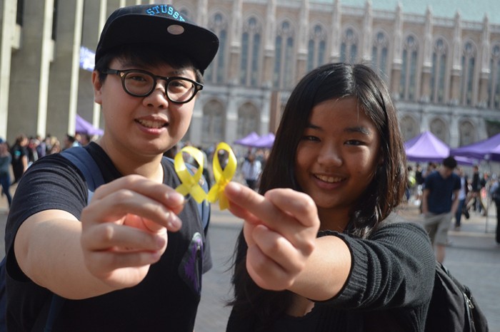 UW students Sophia Lo (Left) and Tina Choi (Right) hold yellow ribbons to show support for the Hong Kong protest. (Photo by Katy Wong)