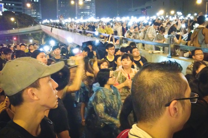 Throngs of young Hongkongers use their cell phones to light up the streets in Admiralty district of Hong Kong last week. (Photo by Yue Ching Yeung)