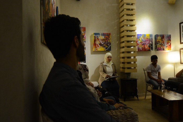 Syrian activists and artists meet for a night of featured poetry about the revolution and the conflict at a cafe in Amman. While the Zaatari camp houses some 85,000 refugees, many Syrians, like Eidmouni, also reside in Jordan's cities. (Photo by Alisa Reznick)