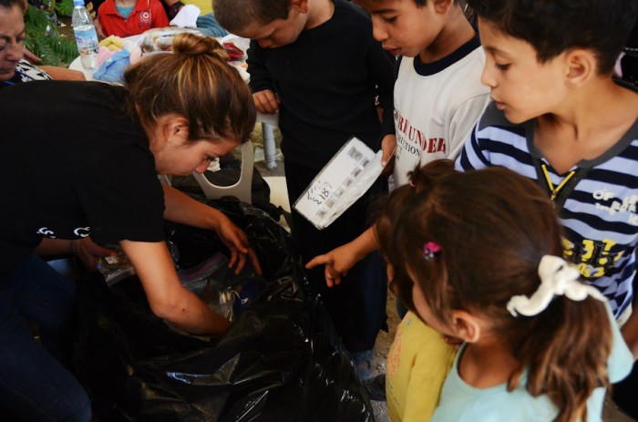 Reham Hamoui looks through a bag of donated toys for refugee children during one of the Salaam Cultural Museum's pop-up clinics just outside Amman. (Photo by Alisa Reznick)