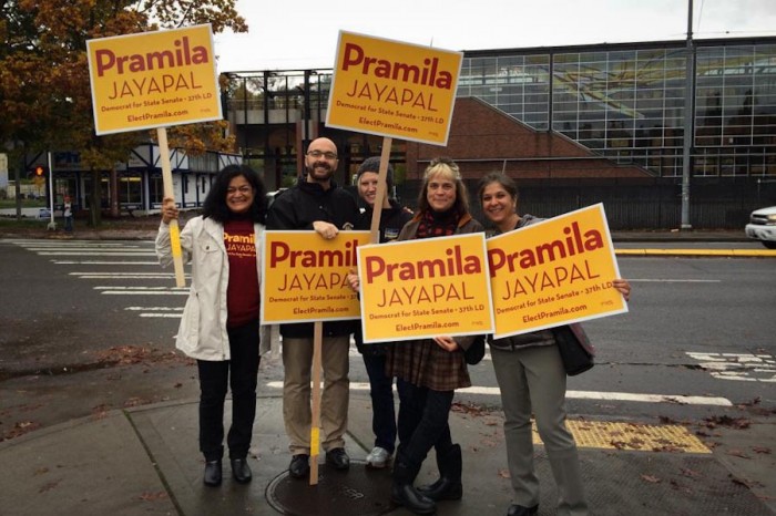 Pramila Jayapal (left) and supporters wave signs at the corner of Martin Luther King, Jr Way and Rainier Ave on Election Day. (Photo courtesy Jayapal for State Senate)