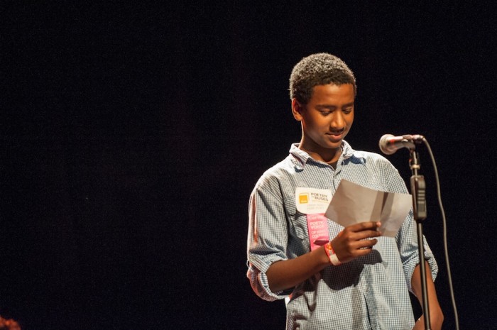 Ethiopian American youth poet Obsa Seid reads at the Poetry on Buses launch Monday night at the Moore Theatre. (Photo by Timothy Aguero)