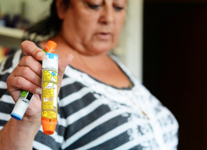 Rita Zawaideh holds a donated Epipen, that will be  taken to Jordan during a humanitarian mission to aid Syrian refugee. (Photo by Alisa Reznick)