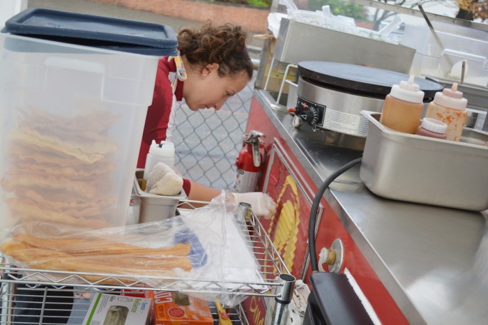 Searfoss prepares and cleans the food cart throughout the day. (Photo by Katy Wong) 