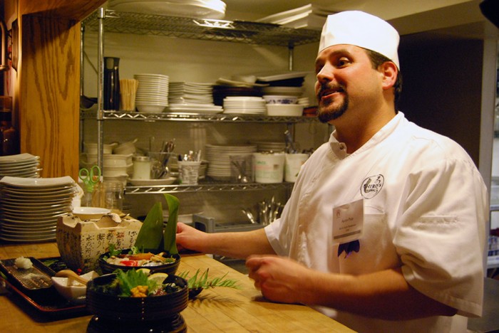 Chef Aaron Pate eagerly talks with guests about his food spread after the competition. (By Ana Sofia Knauf)