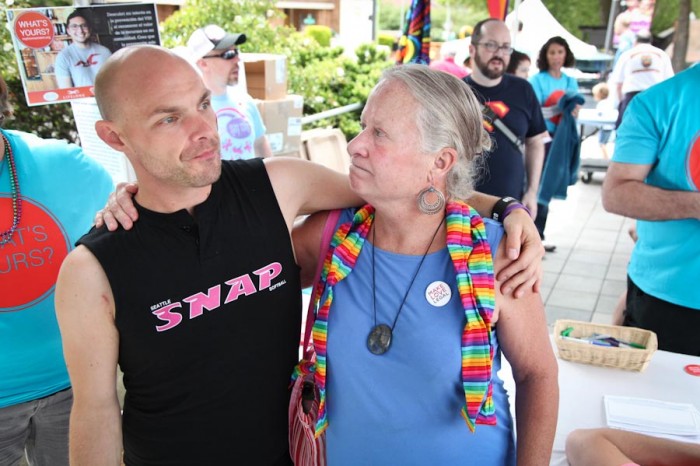 Carol Glenn (right) reunites with Tye Garsen, a volunteer for the Gay City Health Project, at Seattle PrideFest 2014. Glenn's work as a nurse during the height of the AIDS crisis led her to forge strong bonds in the LGBT community. (Photo by Alex Stonehill)