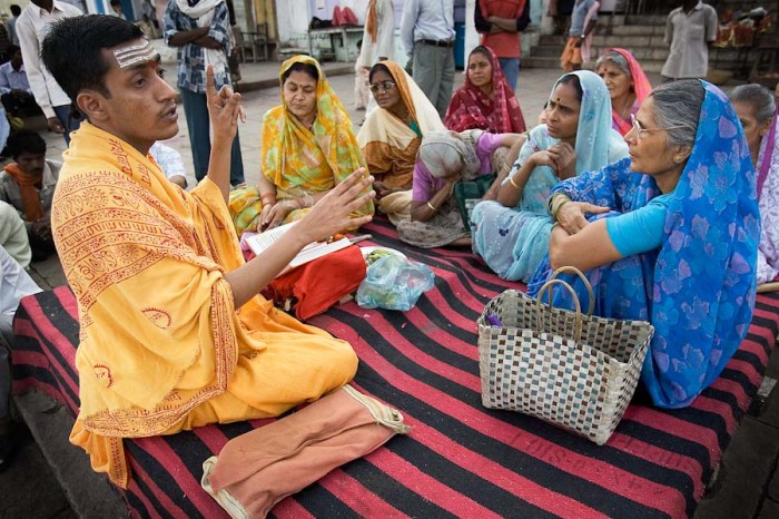 A priest in Varanasi leads women in a class on Hindu scripture — the spiritual yoga. (Photo by Jorge Royan)