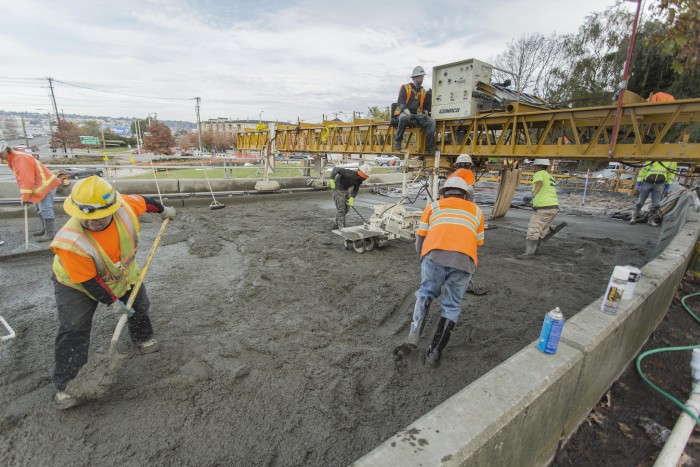 Workers in Seattle lay concrete during the West Emerson Overpass Repair Project in Magnolia. Photo by Seattle DOT.