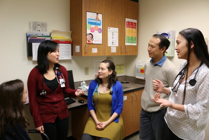 DoQuyen Huynh, DNP-FNP, (right) ICHS ARNP Residency Program Administrator, conducts a briefing on clinical work assignments and issues with program residents (from left) Jean Baumgardner, Kimberly Lee-Cooper, Megan Wilbert, and the program's deputy administrator, Chris Yee, M.D. (Photo courtesy International Community Health Services)