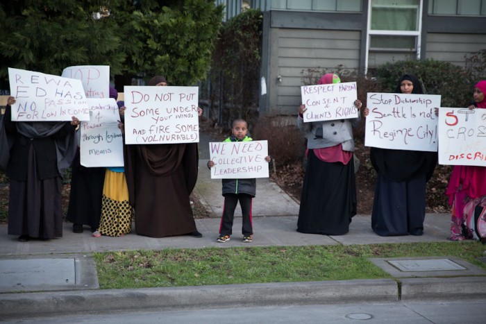 Signs carried by Somali American protesters alluded to complaints about policy at ReWA beyond just the cartoons. (Photo by Alex Garland)