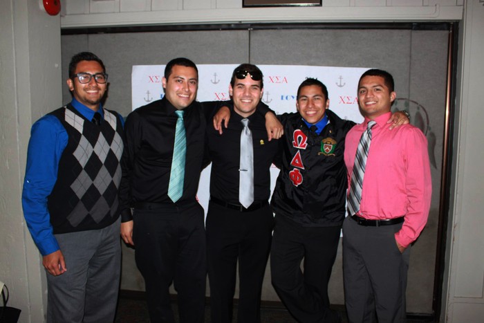 Drew Largé, center, with members of his Hispanic fraternity. (Photo by Kyle Jensen)
