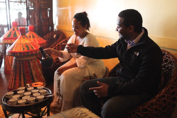 Amen Gibreab (right), director of the film Horeta: The Journey Beyond Culture, enjoys a traditional Ethiopian coffee ceremony performed by Fanaye Debalke at Gojo Ethiopian Restaurant on Aurora Ave. (Photo by Alex Stonehill)