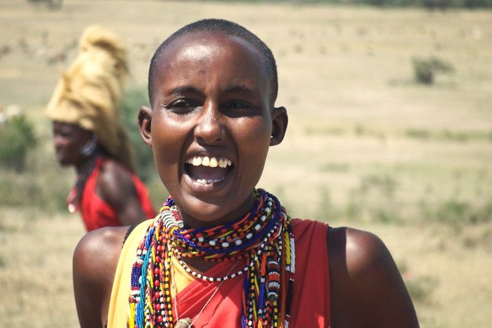 A young Maasai woman with her head shaved — part of many rites of passage in Maasai culture. (Photo from Flickr by Javier Carcamo)