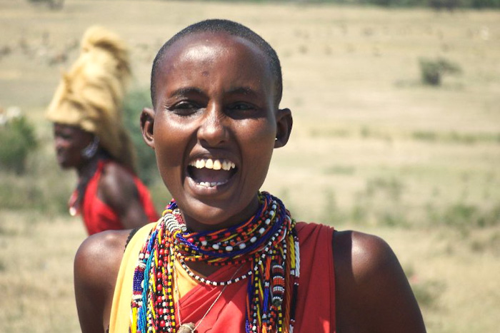 A young Maasai woman with her head shaved — part of many rites of passage in - Javier-Carcamo