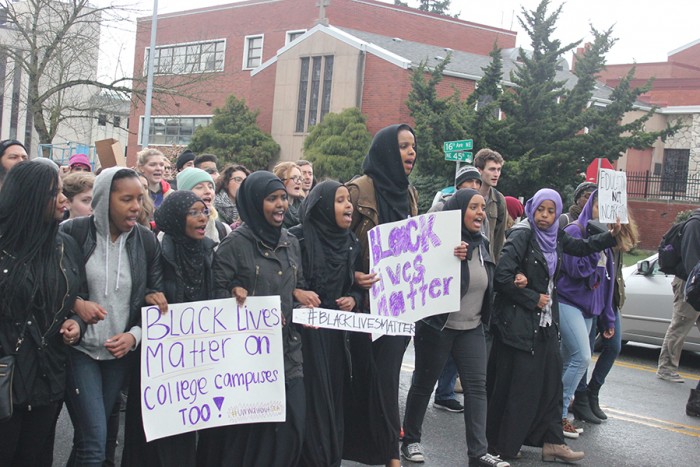 Somali Student Association members link arm and march at a Black Live Matter walkout at UW that drew hundreds. (Photo by Ashley Walls.)