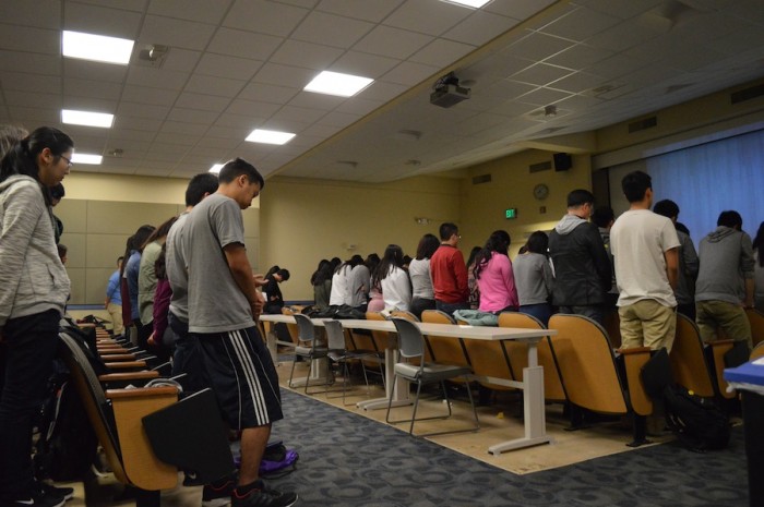 Students at Asian American InterVarsity bow their heads in prayer. Asian American involvement in the UW Christian fellowship has spiked recently. (Photo by Monica Chon)