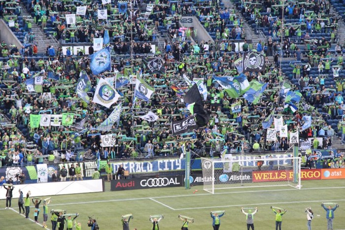 The Emerald City Supporters wave their flag and cheer loudly before the match. (Photo by Justice Magraw)