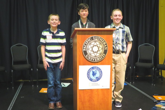 The top three contestants in the Washington State Geographic Bee pose after the conclusion of the finals. From left are fourth grader Jacob Krell (second place), eighth grader Nick Harrington (first place), and seventh grader Evan Scavotto (third place). (Photo by Kyle Haddad-Fonda)