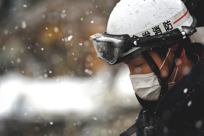 A member of a Japanese Search and Rescue team, still looking for survivors in Unosumai, Japan six days after the earthquake. (Photo by Master Sgt. Jeremy Lock via Flickr)