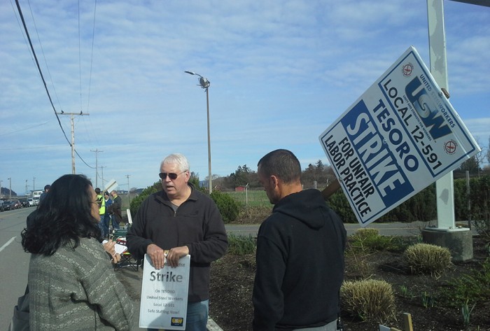 Katrina Pestano (far left) talks to a United Steel Workers Tesoro striker along March Point Road in front of the Anacortes Tesoro oil refinery responsible for the deaths of seven workers in 2010. 