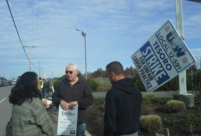 Katrina Pestano (far left) talks to a United Steel Workers Tesoro striker along March Point Road in front of the Anacortes Tesoro oil refinery responsible for the deaths of seven workers in 2010.