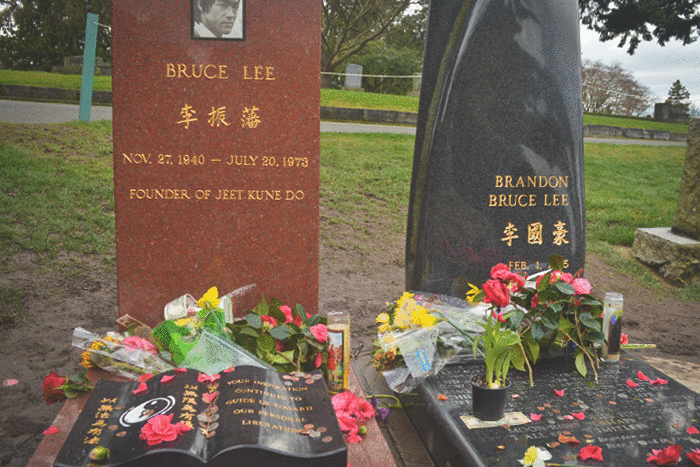 People leave messages and flowers at the grave sites of Bruce Lee and his son, Brandon Lee. (Photos by Chetanya Robinson)
