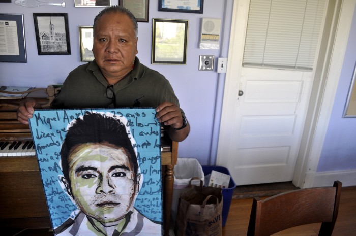Estanislao Mendoza Chocolate at Immanuel Lutheran Church in Seattle with a portrait of his missing son, Miguel Ángel Mendoza Zacarías. (Photo by Janelle Retka)
