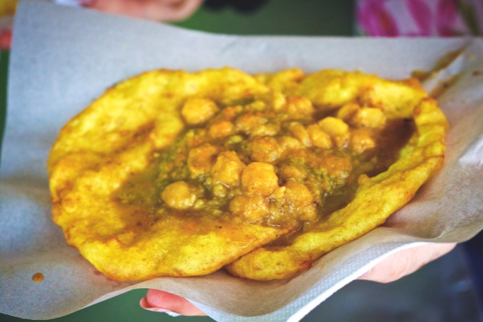 Doubles, a popular street food in Trinidad consisting of chick peas on fried bread, has roots in South Asia but is unique to the Caribbean. (Photo from Flickr by Edmund Gall)