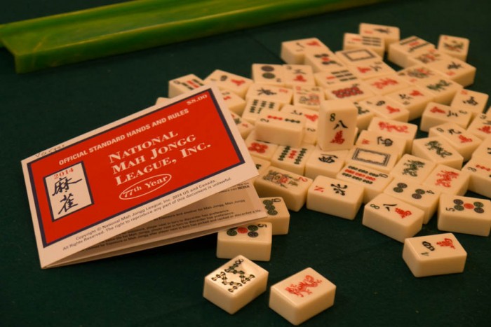 The 2014 version Mah Jongg rule card & the Mah Jongg tiles. (Photo from the Seattle Globalist by Yiqin Weng)