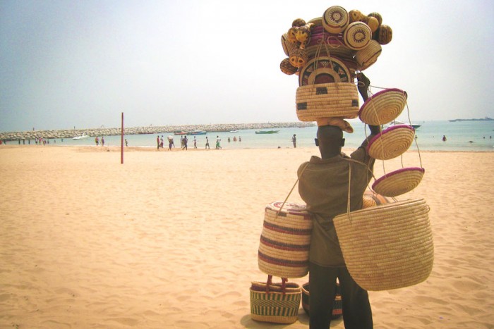 Selling baskets at Tarqa Bay Beach in Lagos. (Photo by Nick M via Flickr)