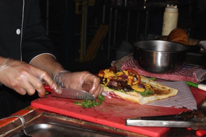 Carlo Antonio Chalisea prepares a Lomo Saltado Sandwich. (Photo by Cristy Acuña)