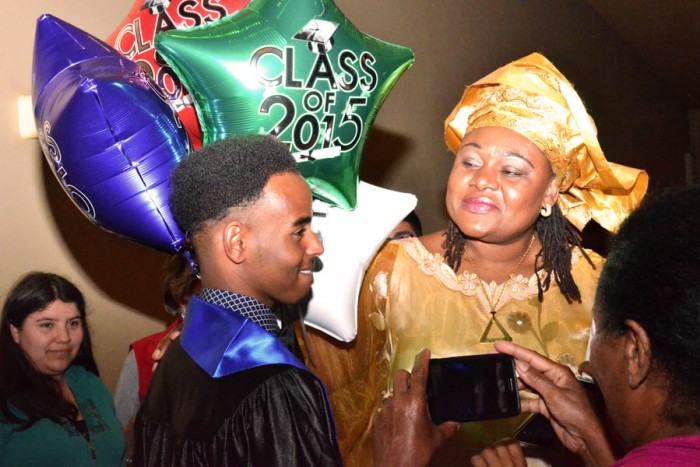 Cynthia Nkeze, ELL teacher at the SWS, looks proudly at her student Abdi Hussein on receiving his high school diploma. (Photo by Valeria Koulikova.)