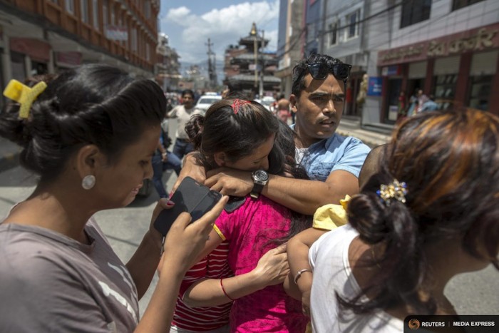 Local residents comfort each others during an earthquake in central Kathmandu, Nepal, May 12, 2015. (Photo from REUTERS/Athit Perawongmetha)