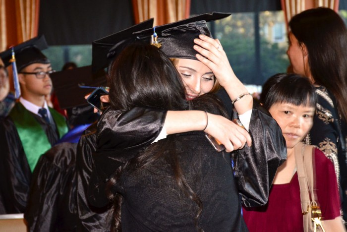 Nino Chaboshvili is congratulated by her best friend on being among the first graduates from the Seattle World School. (Photo by Valeria Koulikova.)