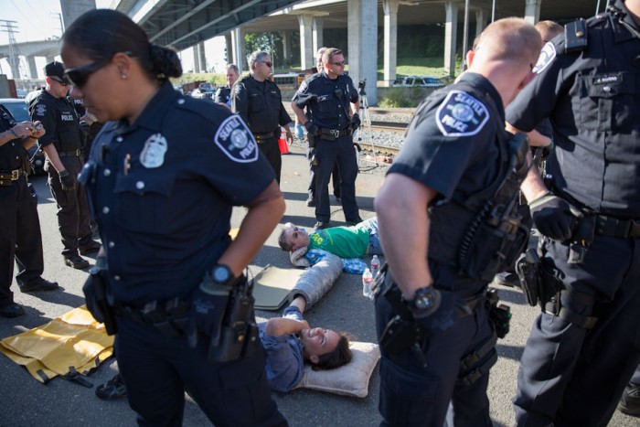 Seattle police arrest protestors blockading access to the Polar Pioneer.