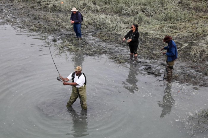 Sport fishermen angle for Silver Salmon in Ship Creek Inlet, in downtown Anchorage. (Photo by Alex Stonehill.)