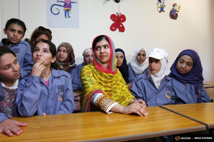 Nobel Peace Prize laureate Malala Yousafzai (center) sits with girls inside a classroom at a school for Syrian refugee girls, built by the NGO Kayany Foundation, in Lebanon's Bekaa Valley on July 12th. (Photo from Reuters / Jamal Saidi)