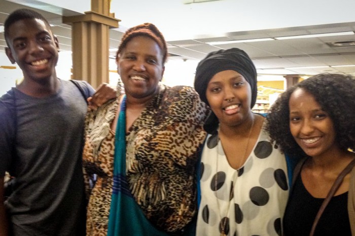 Reagan Jackson (second from left) surrounded by travelers (left to right) Zion Thomas, Azeb Tuji and Eyerusalem Mesele at the Rainier Beach Library researching Mexico before the first Many Voices One Tribe trip abroad. (Photo courtesy Reagan Jackson)