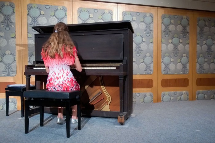 Amy Pottharst, 12, plays a piano that survived the Hiroshima bombing and was later restored. (Photo by Ed Pottharst)