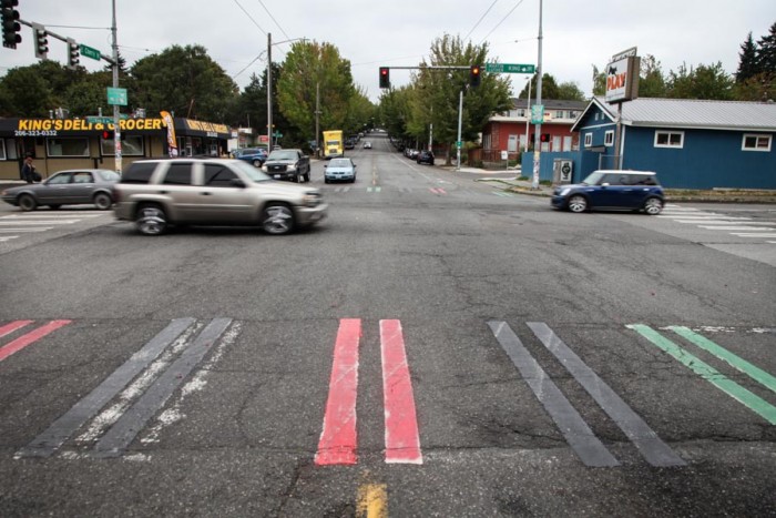 United Hood Movement — an organization of former and current gang members — says they're among those who painted Crosswalks in the Central District red, black and green this weekend. (Photo by Alex Stonehill)