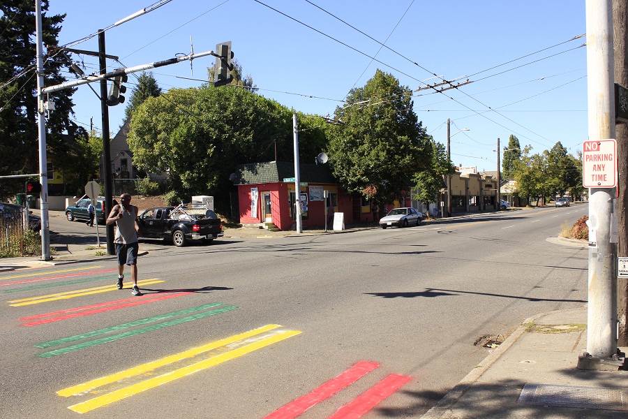 A man jaywalks on a crosswalk that was painted green, yellow, and red for the second time this week, after the first paint job in Ethiopian colors was painted over with white. (Photo by Goorish Wibneh)