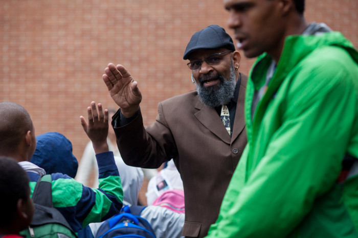 Gerald Donaldson, a Family Support Worker at Leschi Elementary School, high fives students entering the school. (Photo by Jovelle Tamayo)