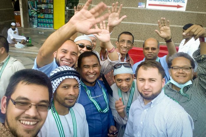 The author (lower left) with other members of the Hajj group from Washington state that he travelled with. Mohamad Joban, Imam of the Muslim Association of Puget Sound is at center in dark blue. (Photo by Tariq Yusuf)